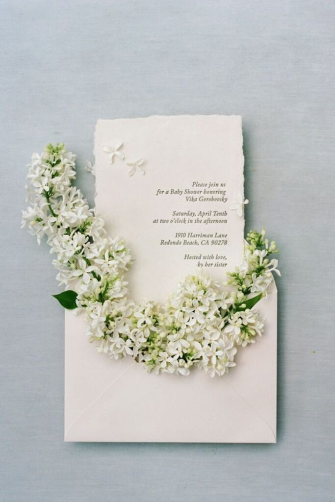 Invitation with flowers coming out of it
