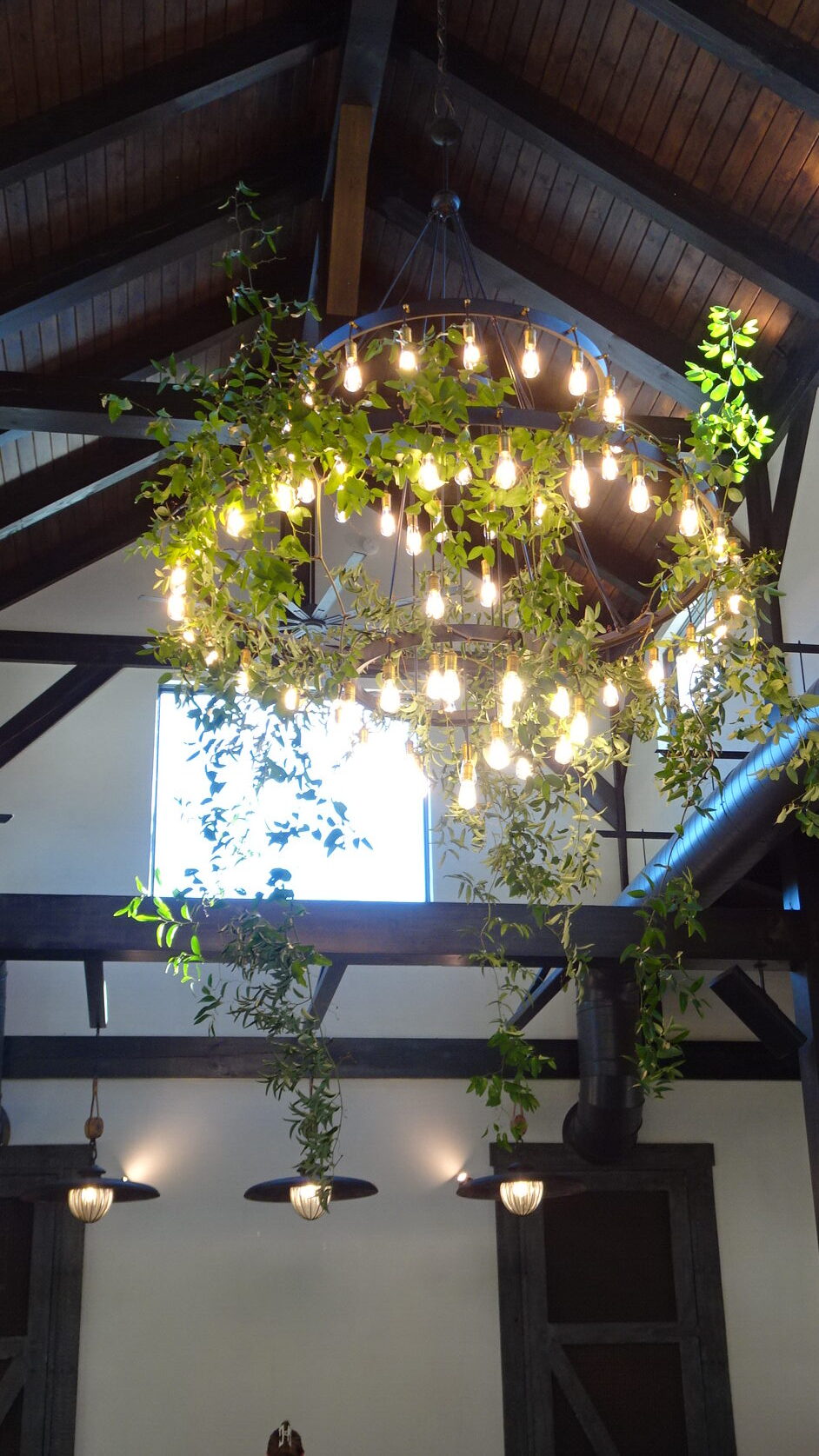 Greenery cascading from a chandelier at a Nashville wedding reception.